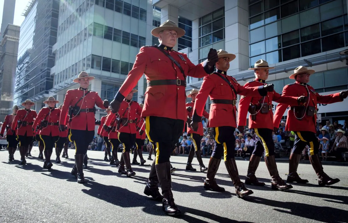 Members of the RCMP march during the Calgary Stampede parade in Calgary on July 6, 2018. (The Canadian Press/Jeff McIntosh)