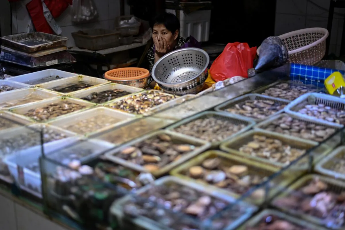 A seafood vendor is waiting for customers at the Huahuan Zhenbei agricultural products market in Shanghai, on Aug. 25, 2020. (Hector Retamal/AFP via Getty Images)