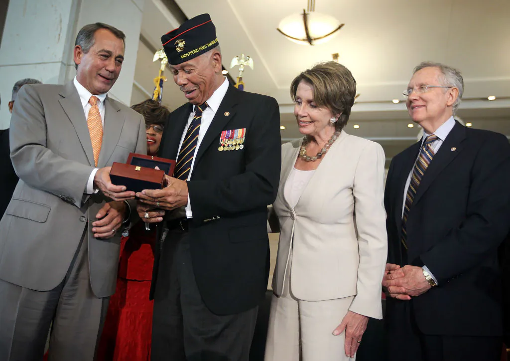 William McDowell (2nd L), a representative of the Montford Point Marines, receives the Congressional Gold Medal from U.S. Speaker of the House Rep. John Boehner (R-OH) (L) as House Minority Leader Rep. Nancy Pelosi (D-CA) (3rd L) and Senate Majority Leader Sen. Harry Reid (D-NV) (4th L) look on during a presentation ceremony at the Emancipation Hall of the Capitol Visitor's Center on Capitol Hill in Washington on June 27, 2012. (Alex Wong/Getty Images)