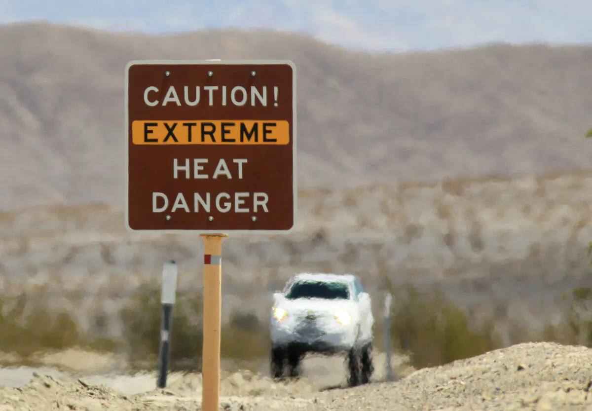 Heat waves rise near a warning sign on July 14, 2013 in Death Valley National Park. (David McNew/Getty Images)