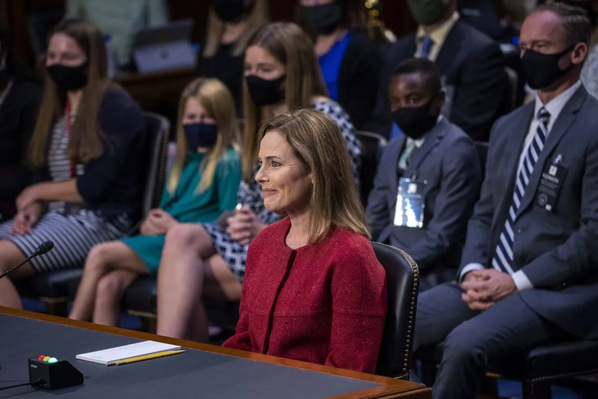 Supreme Court nominee Amy Coney Barrett speaks during a confirmation hearing before the Senate Judiciary Committee on Capitol Hill in Washington, as her family members watch, Oct. 13, 2020. (Shawn Thew/Pool via AP)