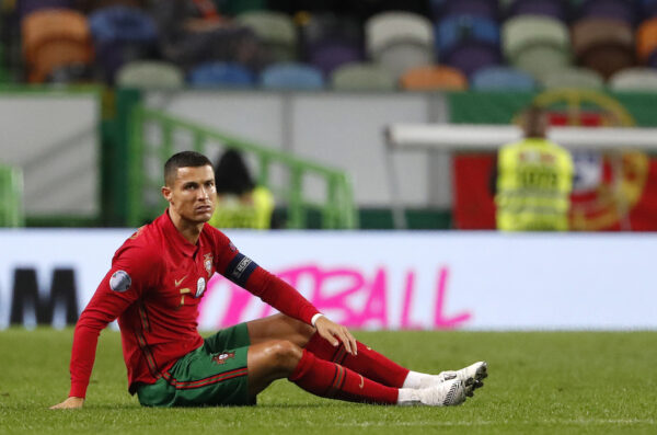 Portugal's Cristiano Ronaldo, right, sits on the pitch during the international friendly soccer match