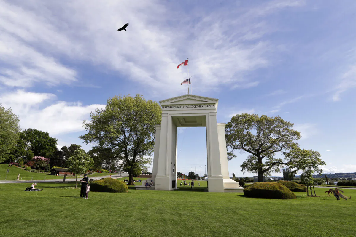 File photo shows Peace Arch in Peace Arch Historical State Park on the border between Blaine, Washington, and Surrey, British Columbia. (AP Photo/Elaine Thompson)