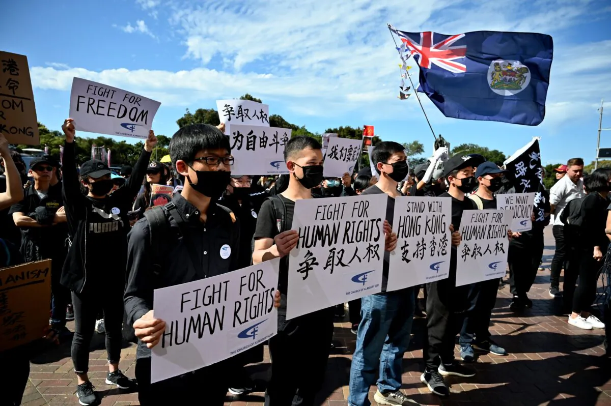 Supporters of the Hong Kong pro-democracy protesters hold placards during a demonstration as part of the global "anti-totalitarianism" movement in Sydney on Sept. 29, 2019. (PETER PARKS/AFP via Getty Images)