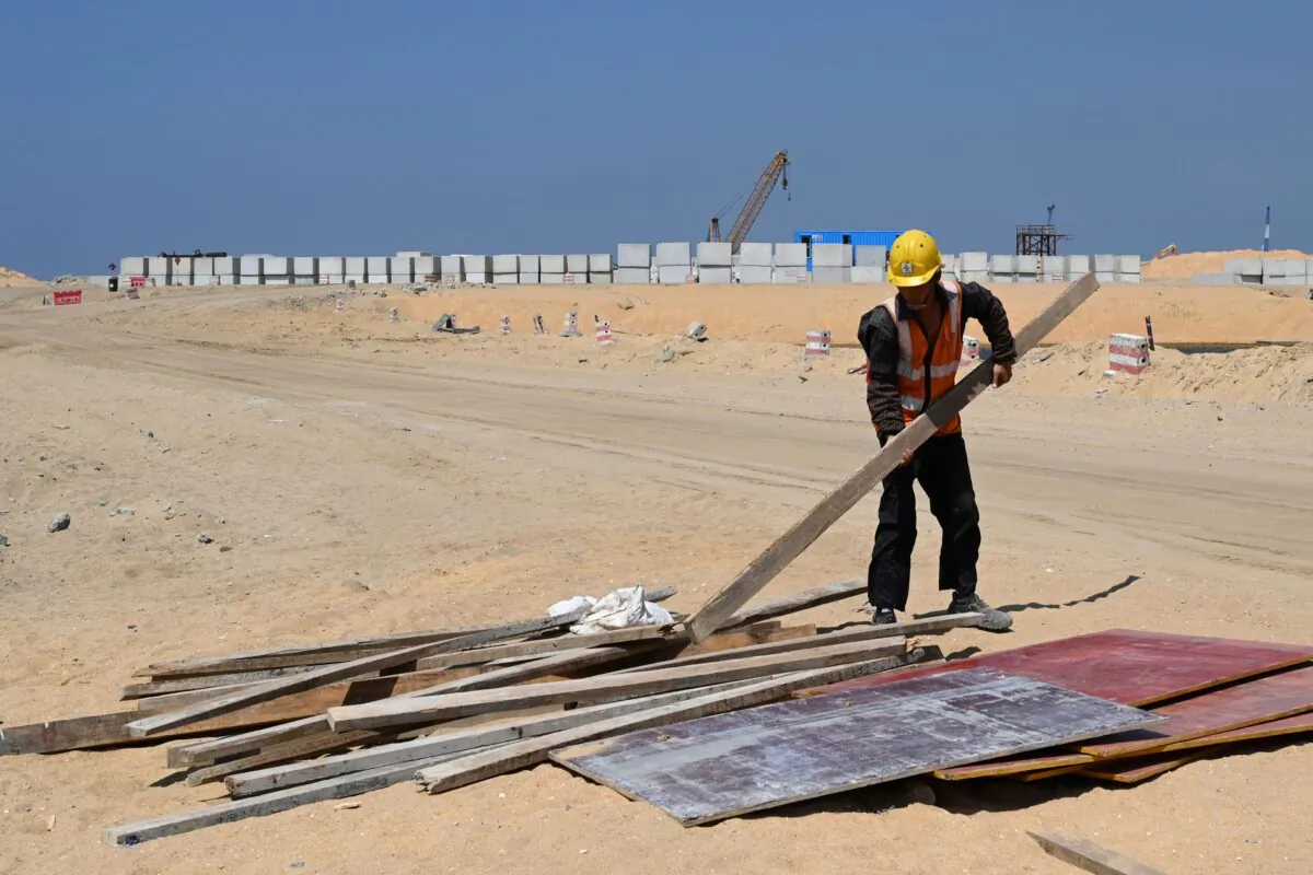 A Chinese laborer works at a construction site on reclaimed land, part of a Chinese-funded project for Port City, in Colombo, Sri Lanka, on Feb. 24, 2020. (Ishara S. Kodikara/AFP via Getty Images)