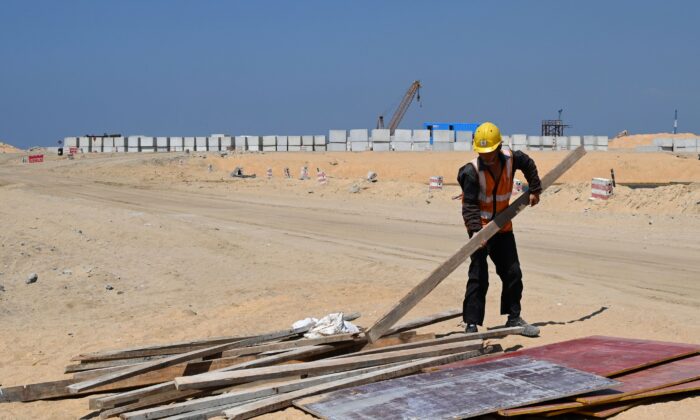 A Chinese laborer works at a construction site on reclaimed land, part of a Chinese-funded project for Port City, in Colombo, Sri Lanka, on Feb. 24, 2020. (ISHARA S. KODIKARA/AFP via Getty Images)