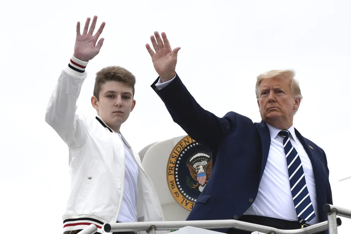 President Donald Trump (R) and his son Barron Trump (L) wave from the top of the steps of Air Force One at Morristown Municipal Airport, in Morristown, N.J., on Aug. 16, 2020. (Susan Walsh/AP Photo)