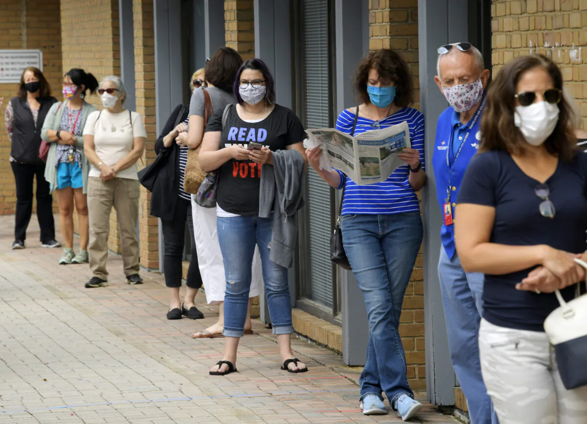 People wait in line at to cast their ballots for the November presidential election on first day of early voting in Alexandria, Va., on Sept. 18, 2020. (John McDonnell/The Washington Post)