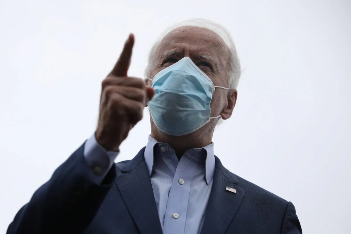 Democratic presidential nominee Joe Biden speaks to journalists before boarding his campaign plane ahead of a trip in New Castle, Del., on Oct. 12, 2020. (Tom Brenner/Reuters)
