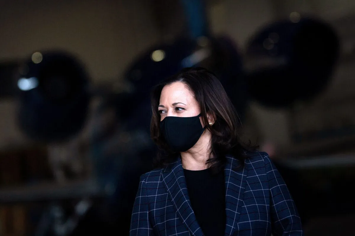 Vice presidential nominee Sen. Kamala Harris (D-Calif.) listens to her running mate speak to reporters at Phoenix Sky Harbor Airport, in Phoenix, Ariz., on Oct. 8, 2020. (Brendan Smialowski/AFP via Getty Images)