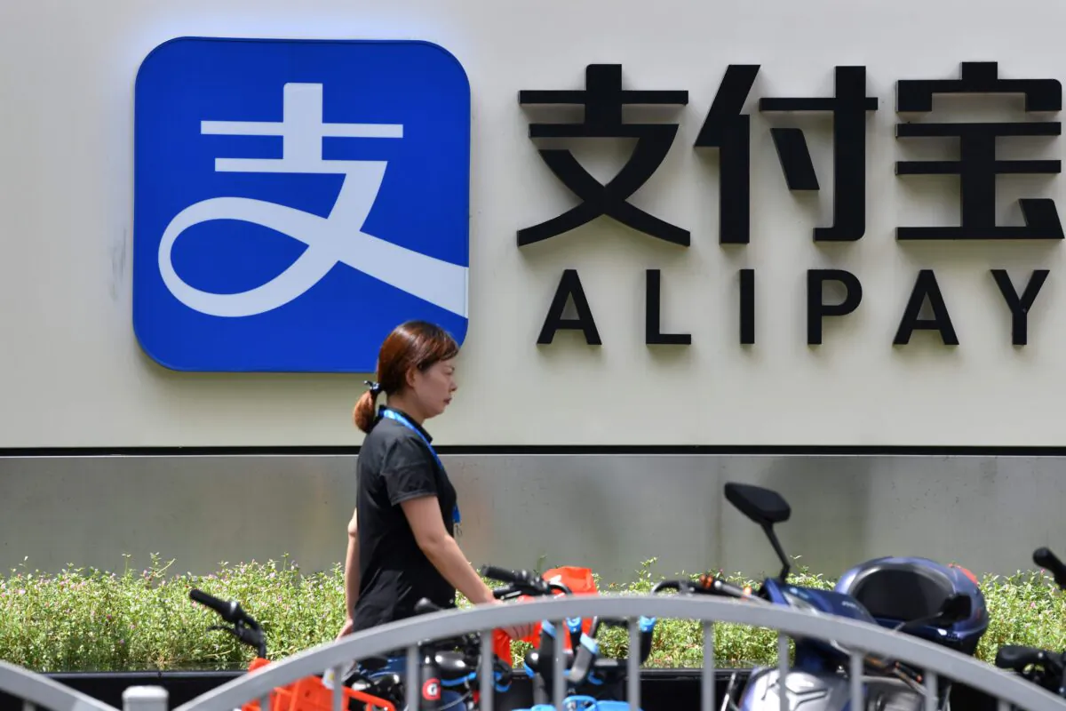 A pedestrian walks past an Alipay logo at the Shanghai office building of Ant Group in Shanghai, on Aug. 28, 2020. (HECTOR RETAMAL/AFP via Getty Images)