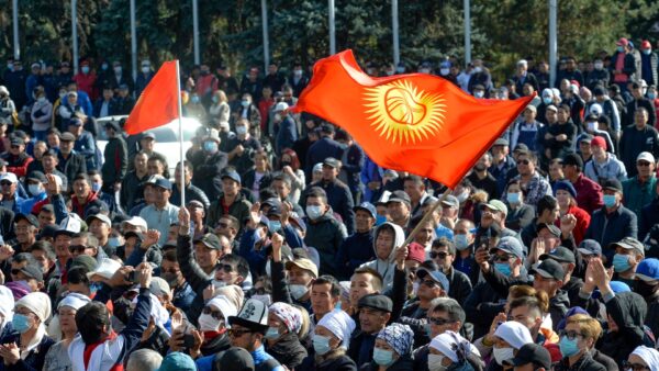 Protesters waving Kyrgyz national flags