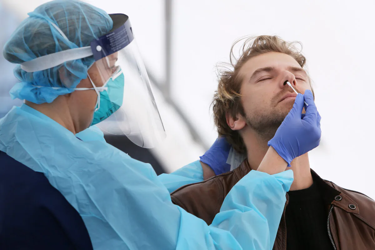 Registered Nurse Michelle Gibbons conducts a COVID-19 swab test on a man at Bondi Beach, in Sydney, Australia, on July 22, 2020. (Lisa Maree Williams/Getty Images)