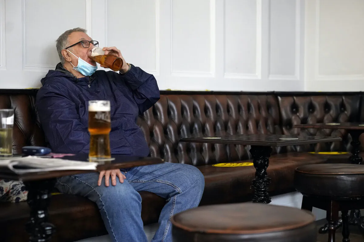 A man drinks beer in a Liverpool city centre pub ahead of the lockdown closure of bars, gyms, and clubs, in Liverpool, England, on Oct. 13, 2020. (Christopher Furlong/Getty Images)