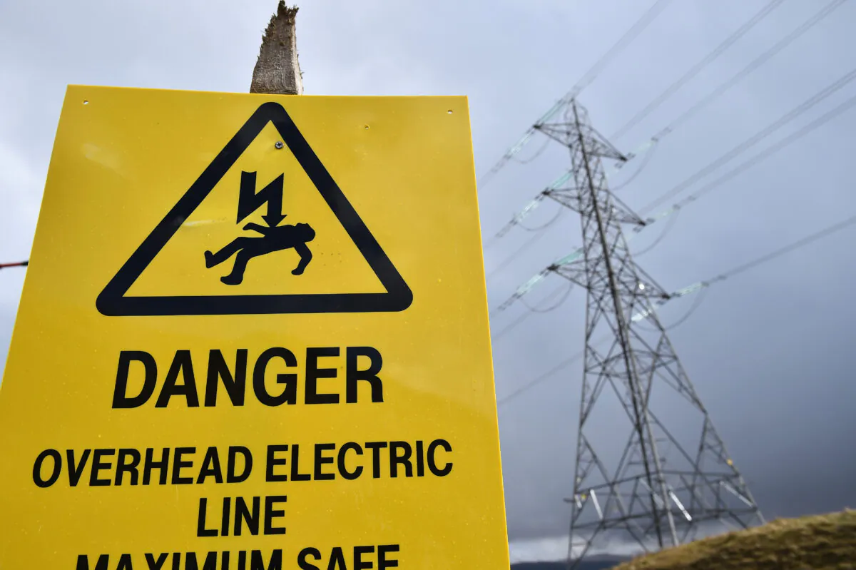A danger sign in front of an electricity pylon in Argyll, Scotland, on March 30, 2016. (Jeff J Mitchell/Getty Images)