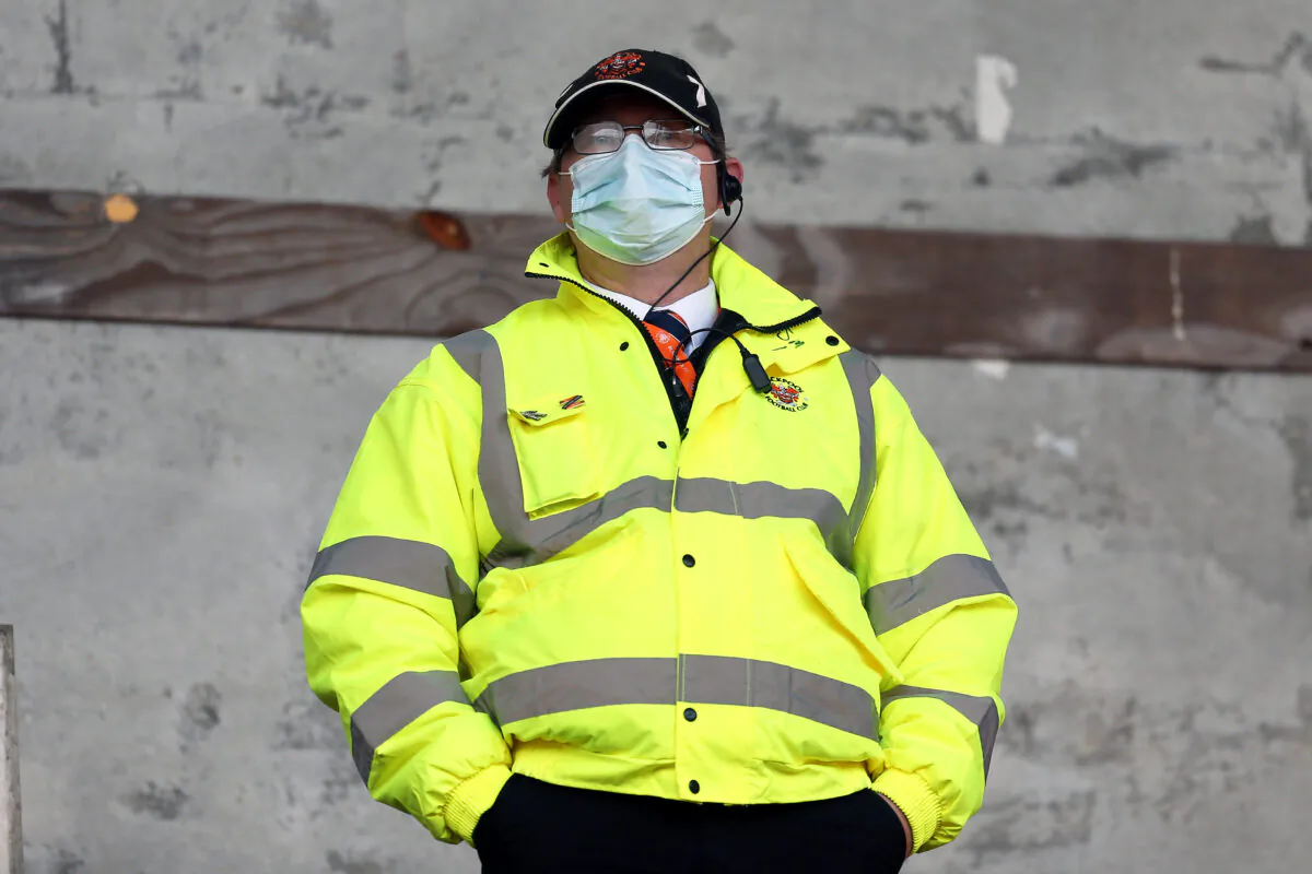A steward wears a mask at a match between Blackpool and Ipswich Town at Bloomfield Road on Oct. 10, 2020 in Blackpool, England. (Lewis Storey/Getty Images)