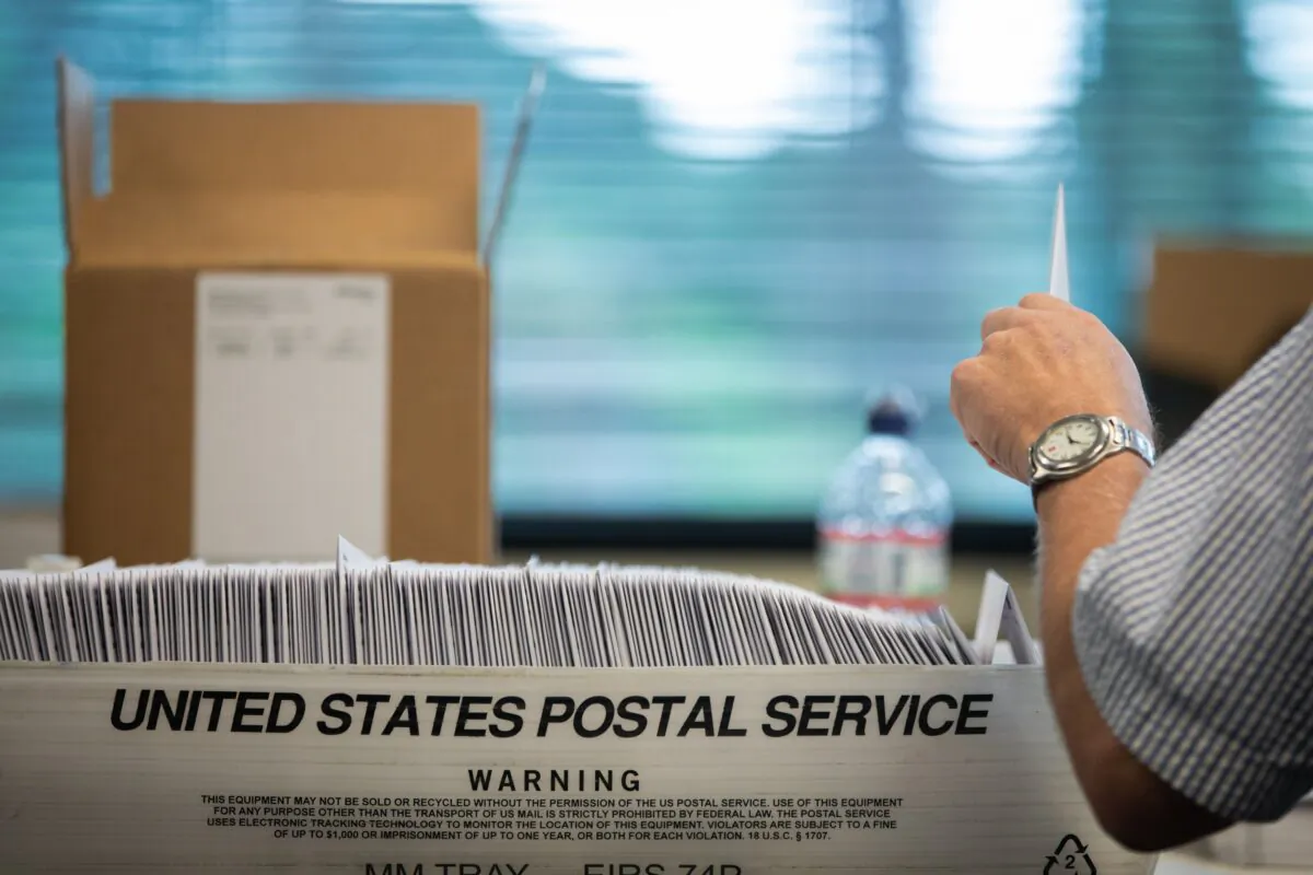 Absentee ballot election workers stuff ballot applications at the Mecklenburg County Board of Elections office in Charlotte, N.C. on Sept. 4, 2020. (Logan Cyrus/AFP via Getty Images)