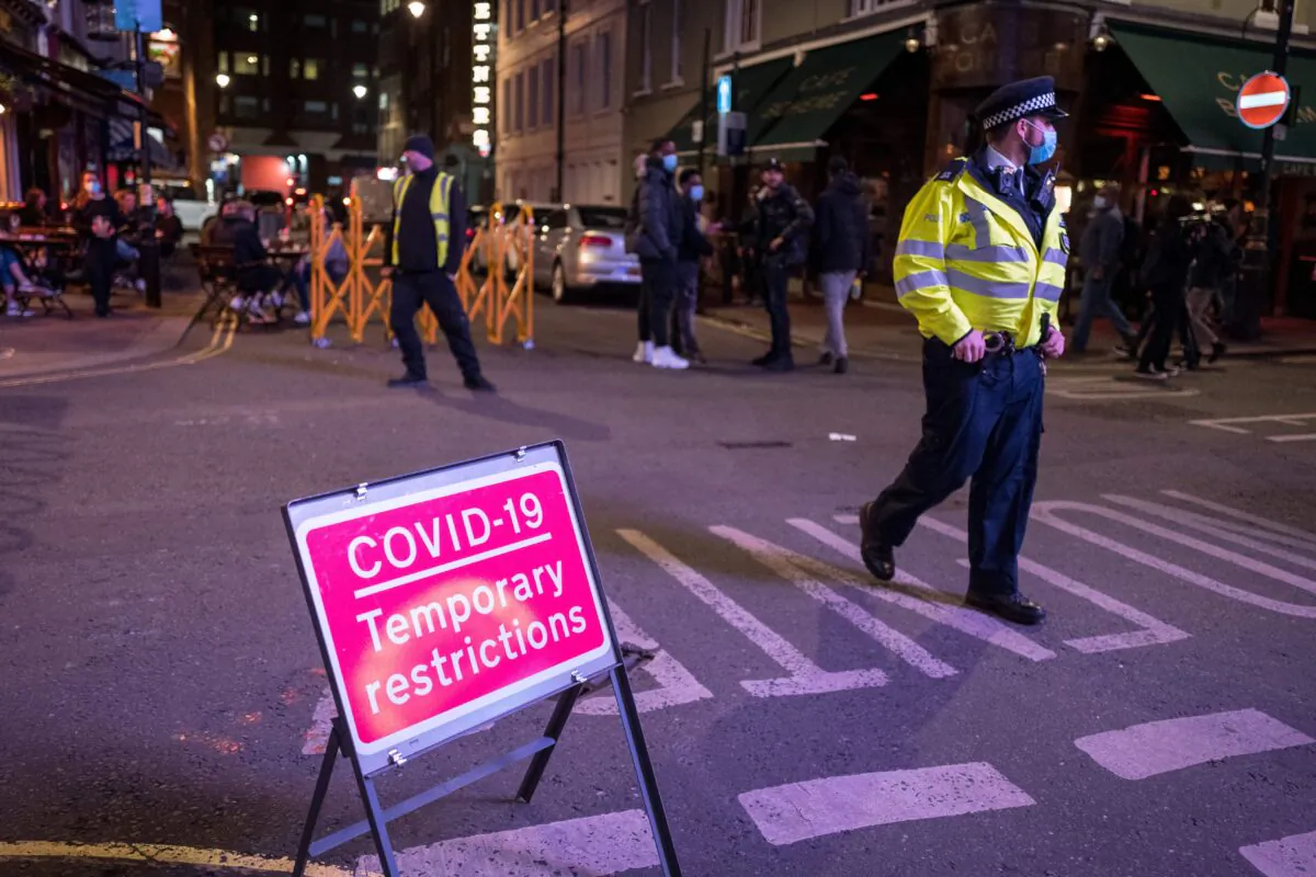 Police patrol in Soho, in central London on Sept. 24, 2020, as the clock nears 10 p.m., on the first day of the new earlier closing times for pubs and bars in England and Wales. (Tolga Akmen/AFP via Getty Images)
