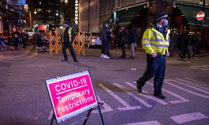 Police patrol in Soho, in central London on Sept. 24, 2020, as the clock nears 10 p.m., on the first day of the new earlier closing times for pubs and bars in England and Wales. (Tolga Akmen/AFP via Getty Images)