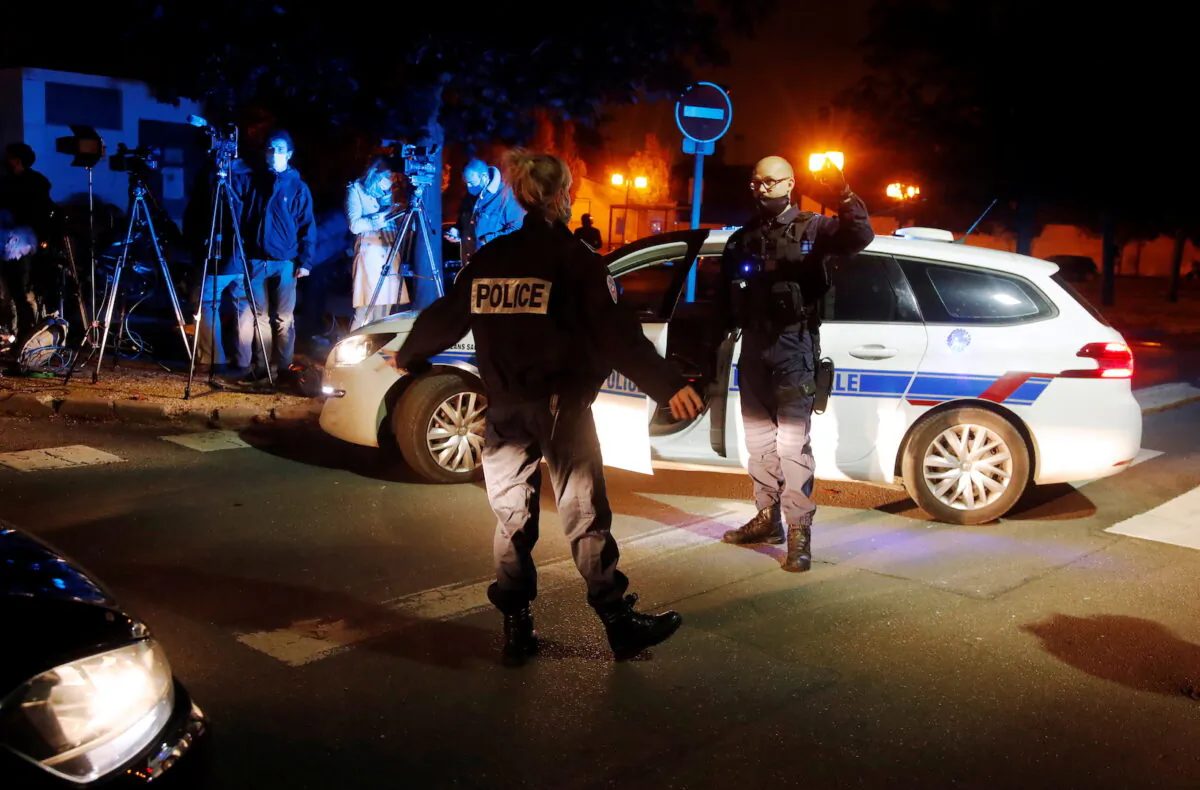 Police officers secure the area near the scene of a stabbing attack in the Paris suburb of Conflans St Honorine, France on Oct. 16, 2020. (Charles Platiau/Reuters)