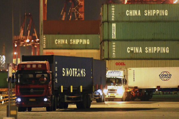 Trucks transport shipping containers