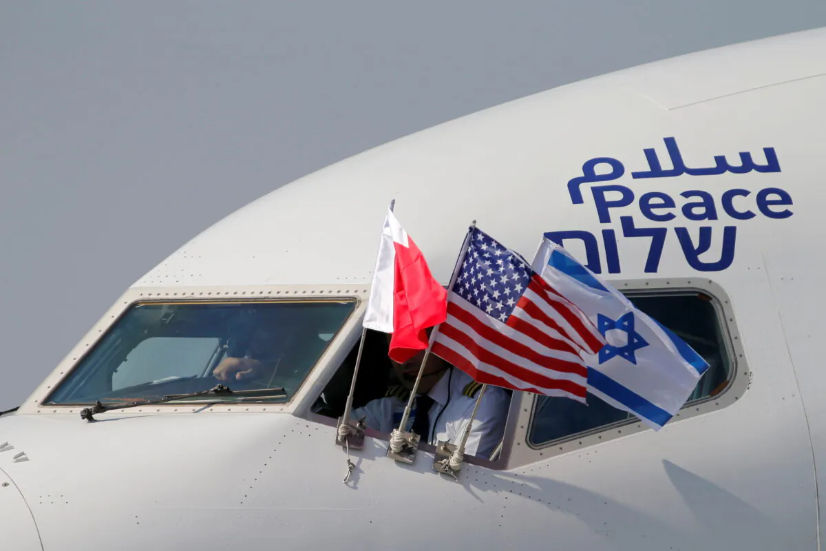 Bahraini, Israeli, and U.S. flags are seen on El Al's airliner carrying an Israeli delegation accompanied by the U.S. treasury secretary as it lands in Muharraq, Bahrain, on Oct. 18, 2020.  (Hamad I Mohammed/Reuters)