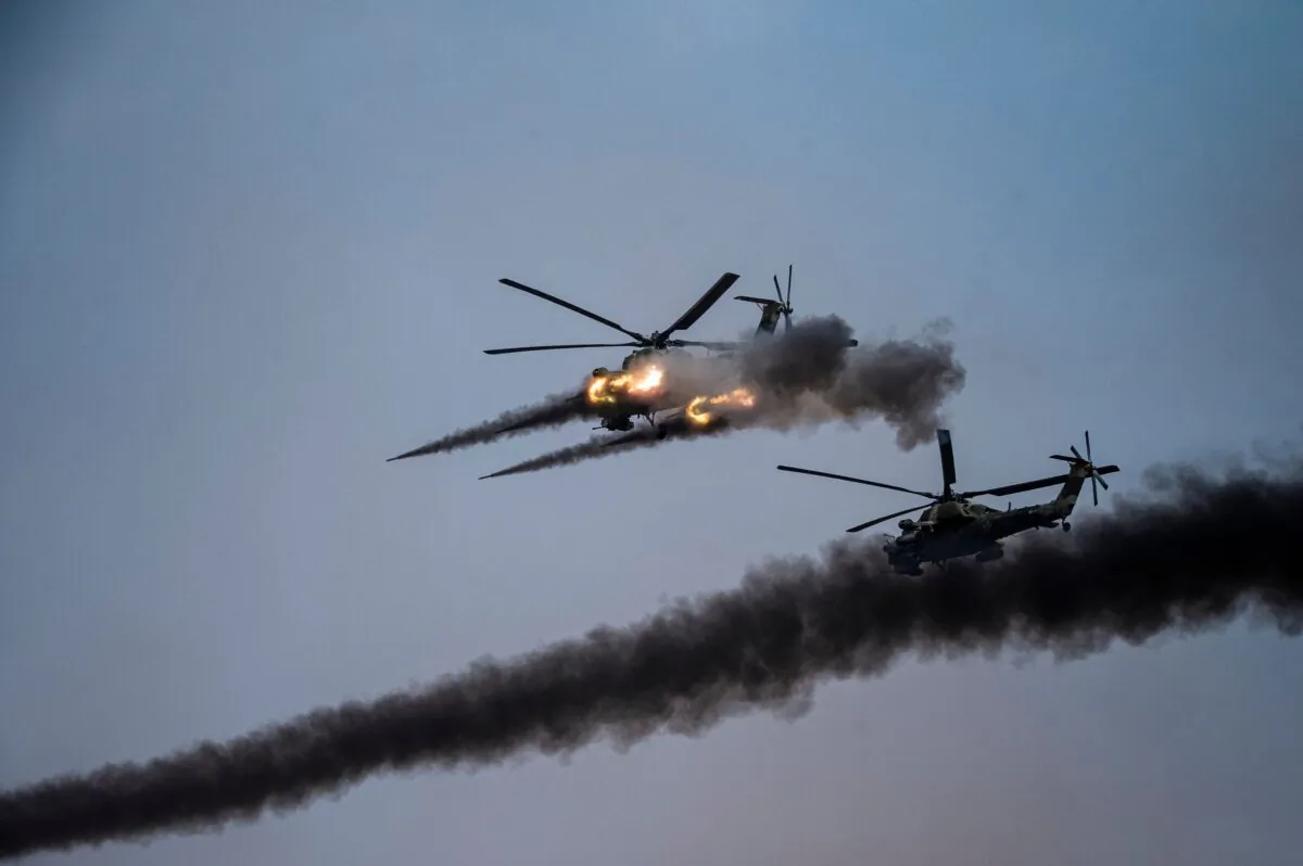 Russian helicopters launch rockets during a join military exercises gathering China, Russia and other countries at the Kapustin Yar range in Astrakhan region, Southern Russia, on Sept. 25, 2020. (DIMITAR DILKOFF/AFP via Getty Images)