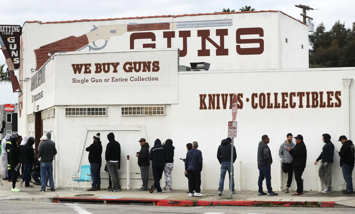 People stand in line outside a gun store in Culver City, Calif., on March 15, 2020. (Mario Tama/Getty Images)