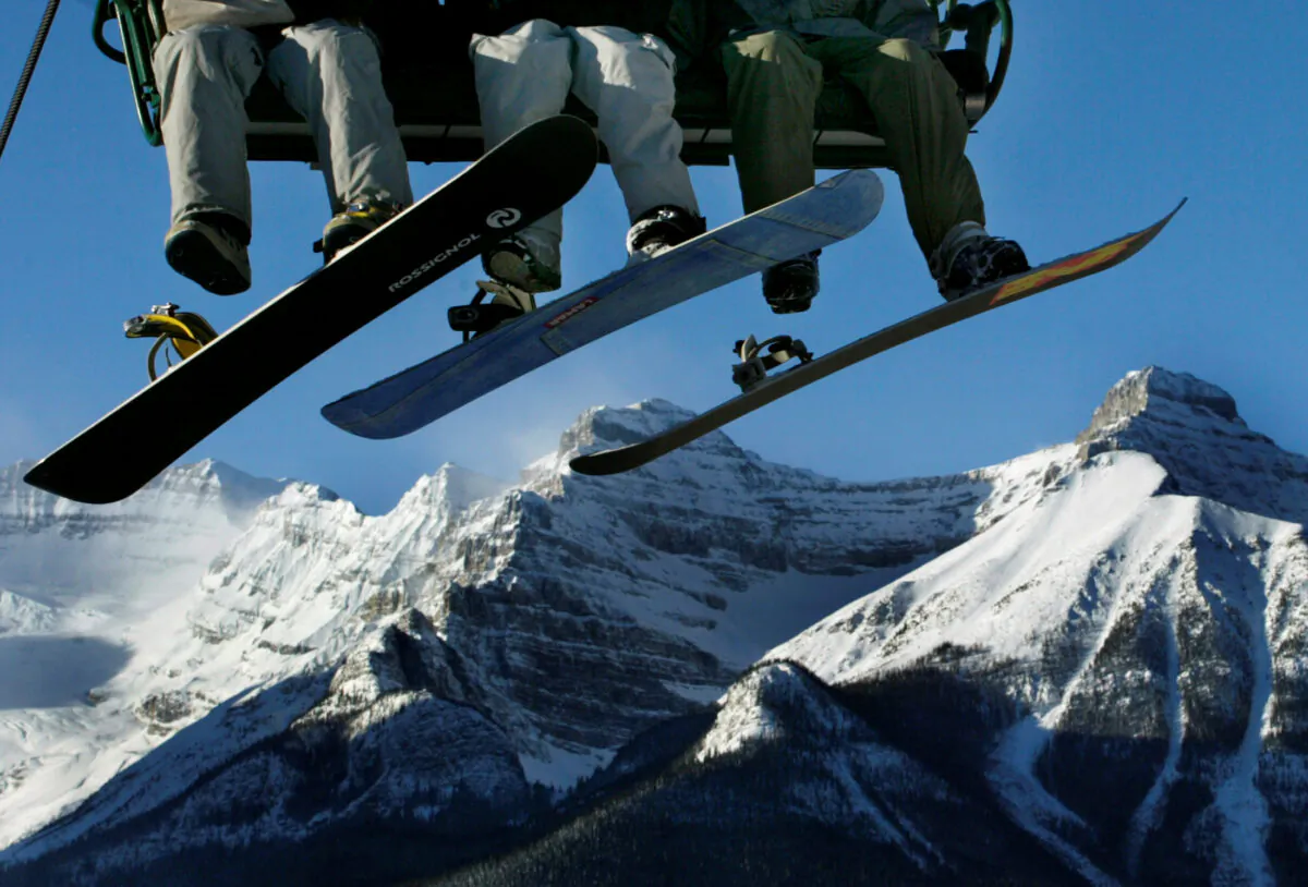 Snowboarders ride the ski lift at Lake Louise, Alberta, in this file photo. (Reuters/File Photo)