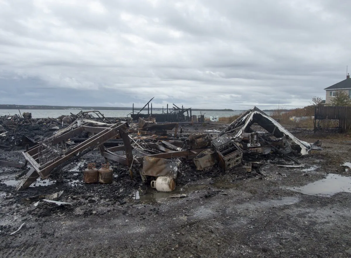 Tensions remain high over an Indigenous-led lobster fishery that has been the source of conflict. Debris from a burnt out fish plant is scattered along the shore in Middle West Pubnico, N.S., Canada on Oct. 17, 2020. (The Canadian Press/Andrew Vaughan)