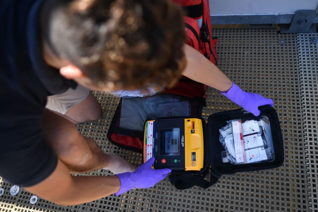 RNLI lifeguard supervisor Sam Woodard checks a defibrillator as he prepares a lifeguard station on the beach at Viking Bay in Broadstairs, south-east England, on May 28, 2020, during the COVID-19 pandemic. (Ben Stansall/AFP via Getty Images)