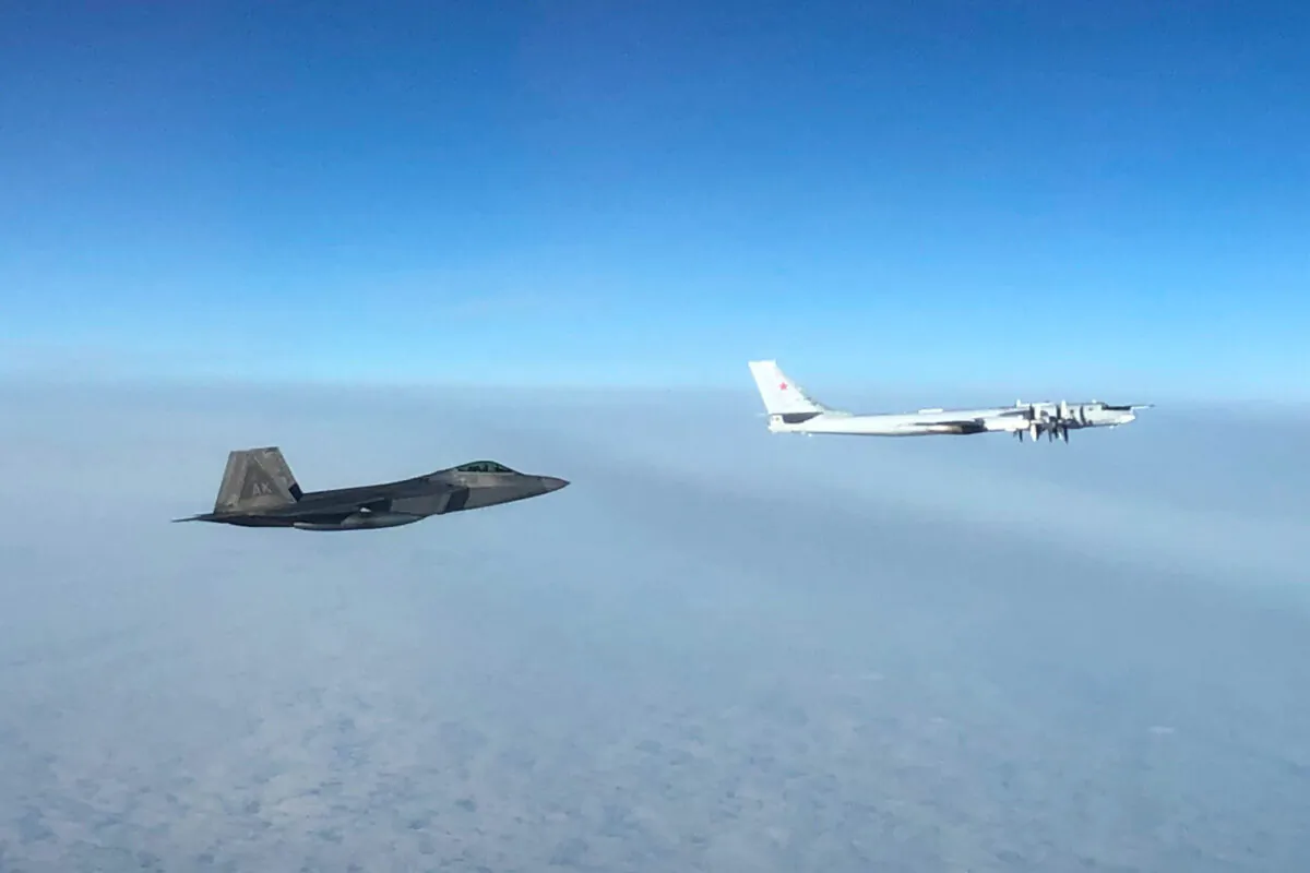An F-22 "Raptor" fighter jet (under) intercepts a Russian Tu-95 bomber after it entered the Alaskan Air Defense Identification Zone on Oct. 19, 2020. (NORAD)