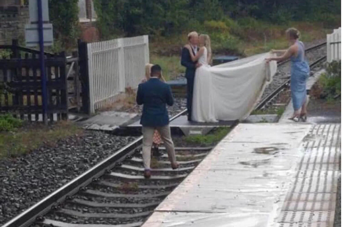 A CCTV still shows a couple on the train line at Whitby in North Yorkshire, taken on an unspecified date in summer 2020. (Network Rail) 
