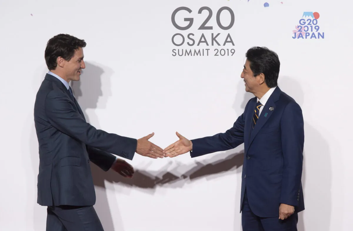 Japanese Prime Minister Shinzo Abe welcomes Canadian Prime Minister Justin Trudeau during the official welcome ceremony at the G20 Summit in Osaka, Japan, on June 28, 2019. Foreign policy experts agree Canada needs to forge closer ties with Japan as part of being more involved in the Indo-Pacific region. (The Canadian Press/Adrian Wyld)