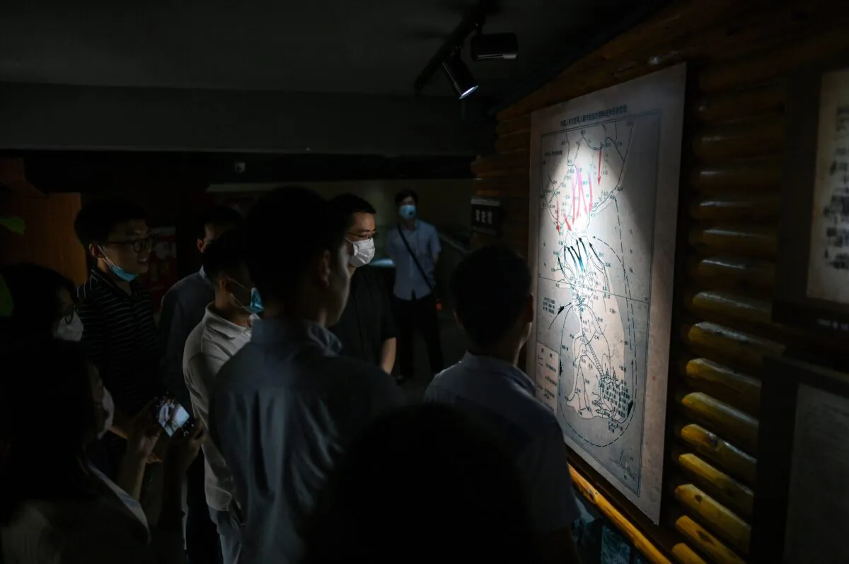 Chinese people look at a map of the Korean peninsula at Chinese People's Volunteer Army Commemorative Museum in Shanghai, China on June 17, 2020. (HECTOR RETAMAL/AFP via Getty Images)