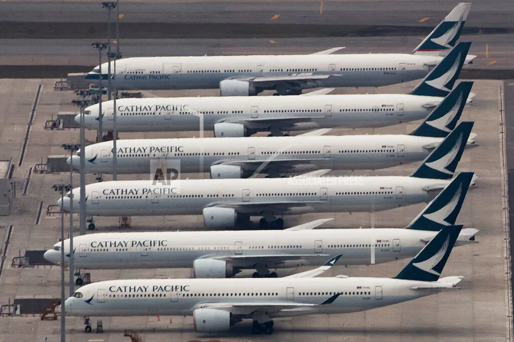 Cathay Pacific Airways aircrafts line up on the tarmac at the Hong Kong International Airport, on March 6, 2020. Hong Kong airline Cathay Pacific Airways on Wednesday, Oct. 21, 2020, said it would cut 8,500 jobs and shut down its regional airline unit in a corporate restructuring, as it grapples with the plunge in air travel due to the pandemic. (Kin Cheung/AP Photo)