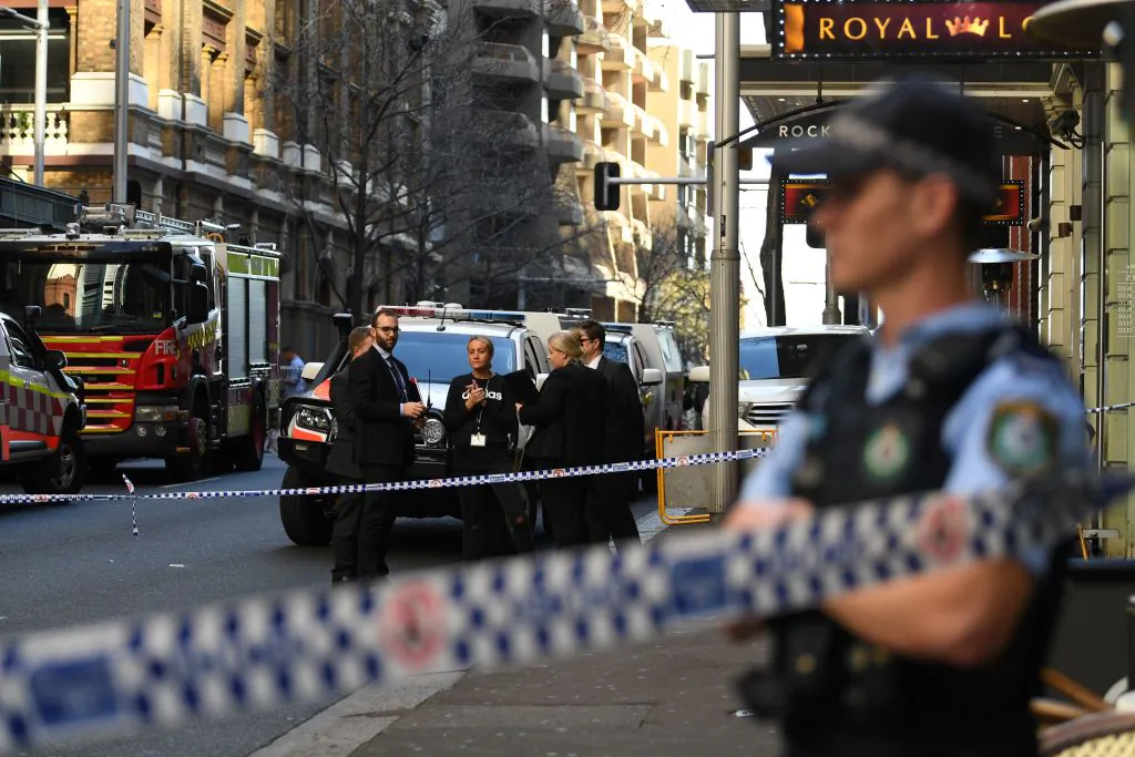 Police gather at the crime scene after a man stabbed a woman and attempted to stab others in central Sydney on August 13, 2019, before being pinned down by members of the public and detained by police. - Police said the woman was in a stable condition and there were no immediate reports of other injuries, despite "a number of attempted stabbings by the same offender." (Photo by Saeed KHAN / AFP) (Photo credit should read SAEED KHAN/AFP via Getty Images)