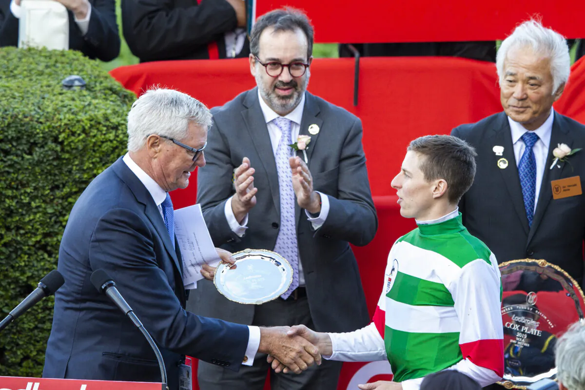 (Center) Racing Minister Martin Pakula, (Right) Damian Lane, is congratulated at a trophy presentation after winning race 9 the Ladbrokes Cox Plate on Lys Gracieux during Cox Plate Day at Moonee Valley Racecourse in Melbourne, Australia on Oct. 26, 2019. (Jenny Evans/Getty Images)