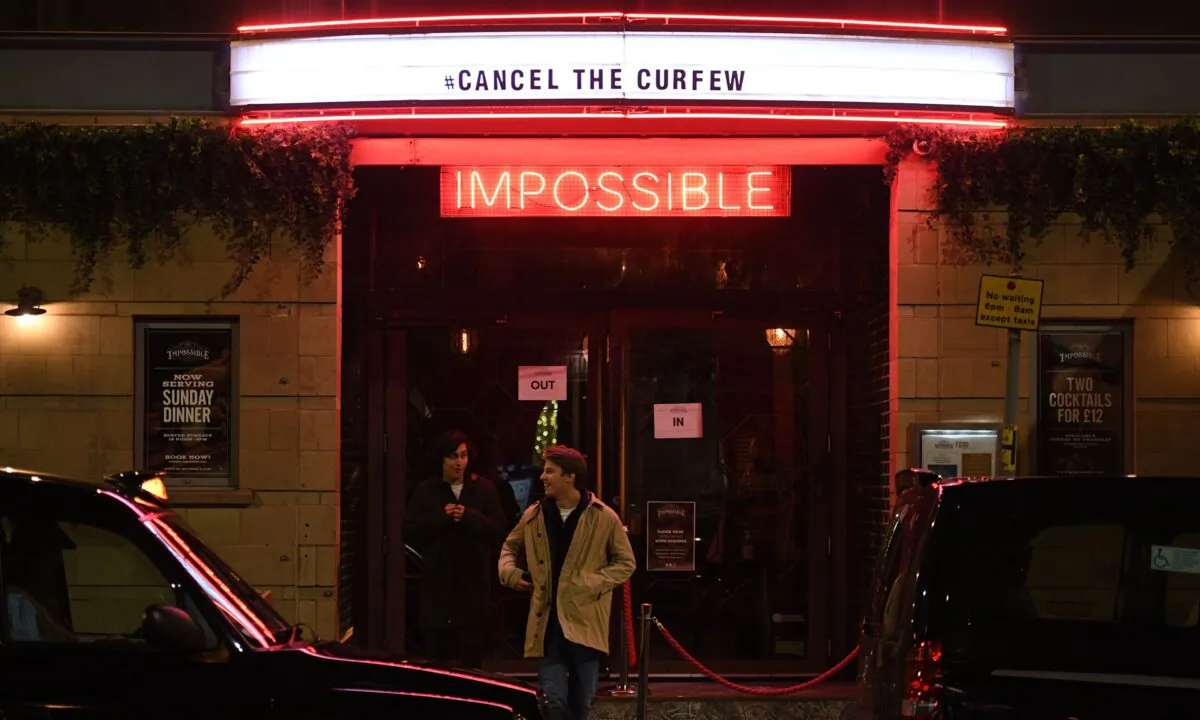 People leave a bar in the city centre of Manchester, England, on Oct. 8, 2020. (Oli Scarff/AFP via Getty Images)