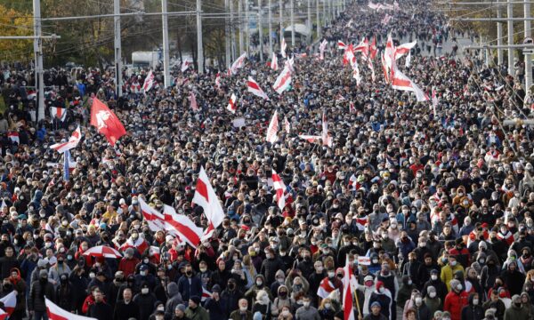 People with old Belarusian national flags march