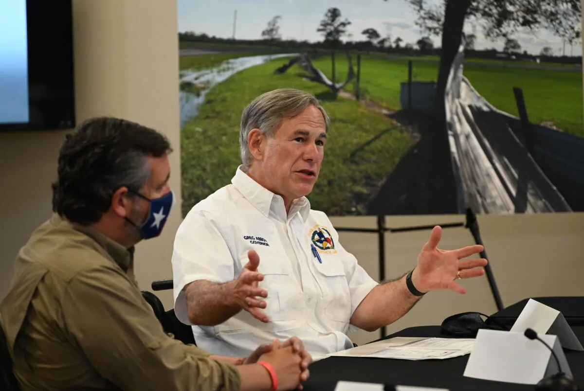 Texas Governor Greg Abbott (R), with US Senator Ted Cruz (L), attends a briefing for President Donald Trump in Orange, Texas, on August 29, 2020.  (ROBERTO SCHMIDT/AFP via Getty Images)