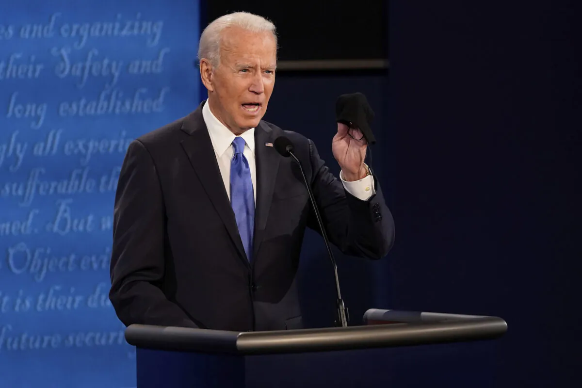 Democratic presidential candidate former Vice President Joe Biden holds up a mask during the second and final presidential debate in Nashville, Tenn., on Oct. 22, 2020. (Morry Gash, Pool/AP Photo)