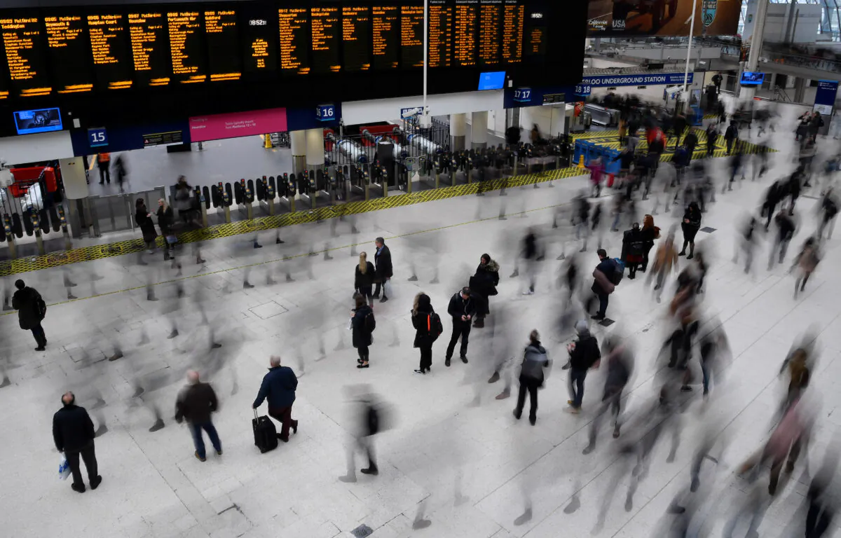 File photo shows workers arriving during the morning rush hour at Waterloo Station in London on March 4, 2020. (Toby Melville/Reuters)