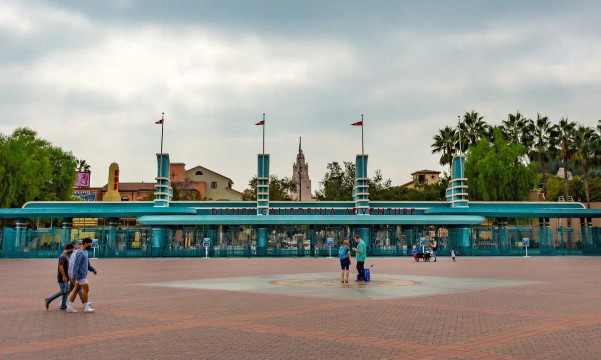Visitors pass by the entrance to the Disney California Adventure theme park, which remains closed due to the COVID-19 pandemic, in Anaheim, Calif., on Oct. 21, 2020. (John Fredricks/The Epoch Times)