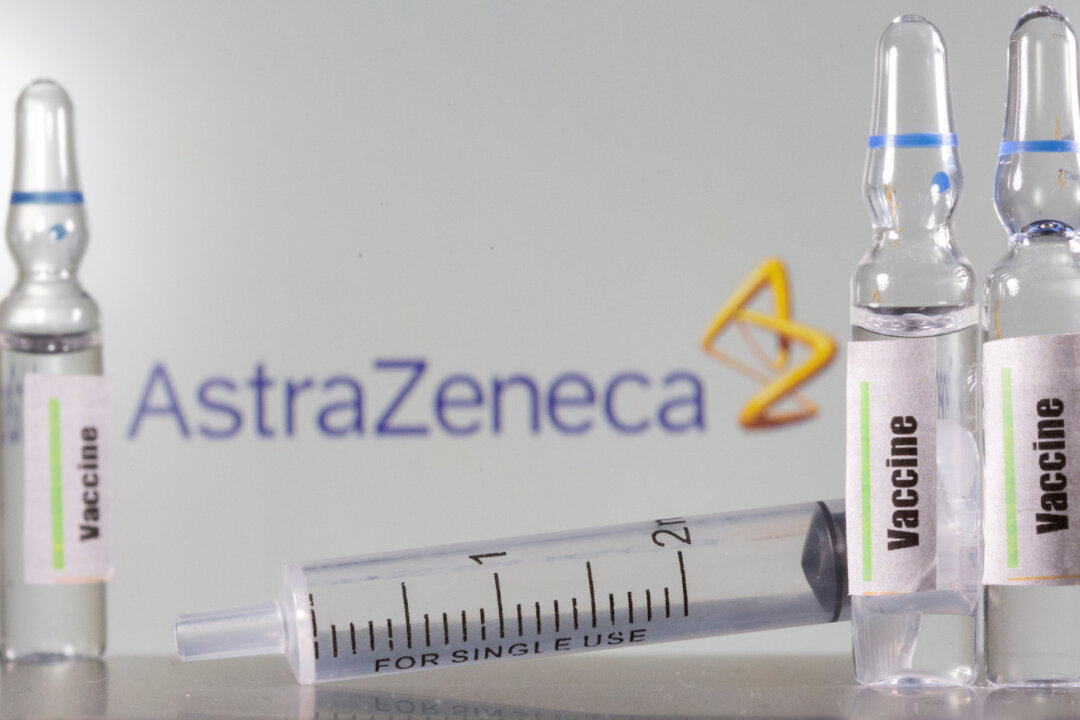 Vials labeled "vaccine" in front of the AstraZeneca logo. (Dado Ruvic/Illustration/Reuters)