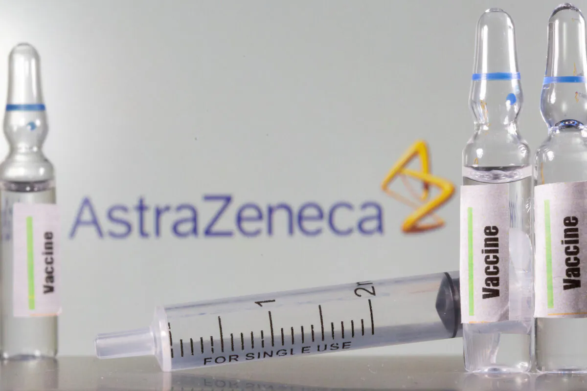 A test tube labeled vaccine is seen in front of AstraZeneca logo. (Dado Ruvic/Illustration/Reuters)