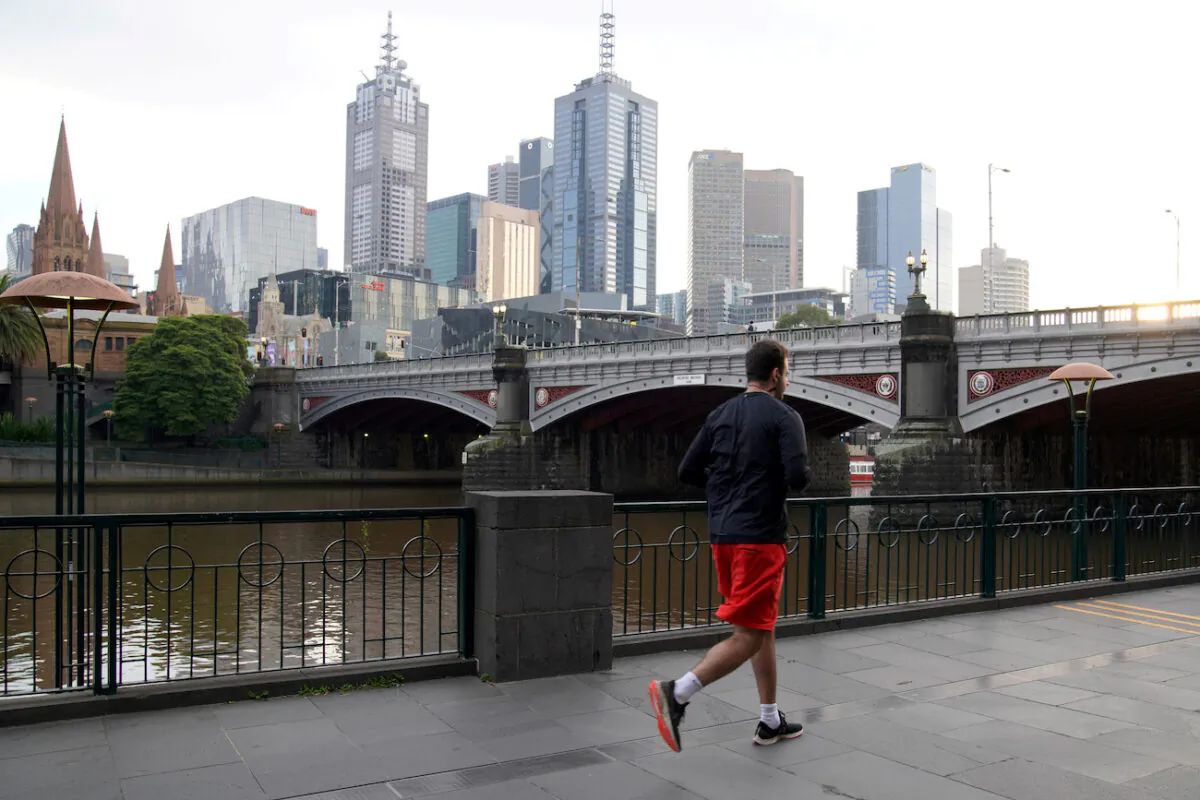 A man runs along a waterway amid lockdown restrictions in Melbourne, Australia, on July 10, 2020.  (Sandra Sanders/Reuters)