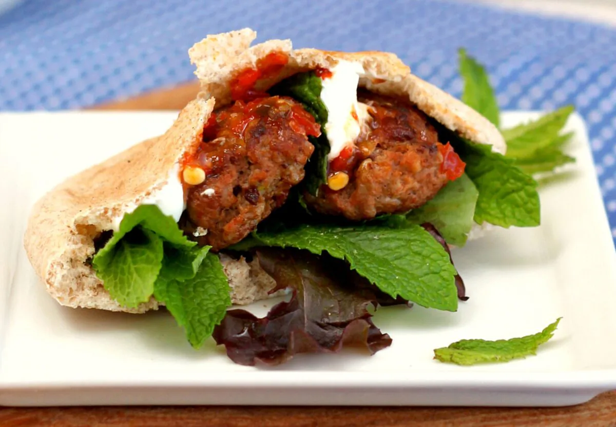 These patties are easy to eat—grilled or pan-fried, stuffed in pita, piled on couscous, and drizzled with a garlicky yogurt sauce. (Lynda Balslev for TasteFood)