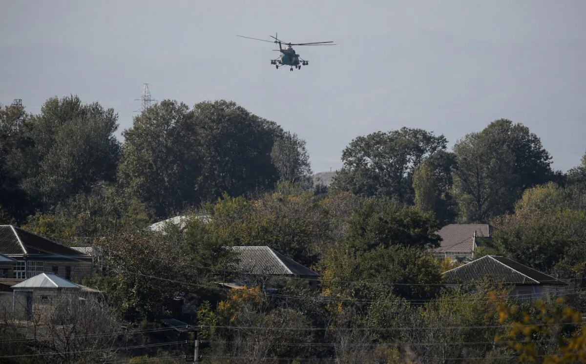 An Azerbaijani military helicopter flies during the fighting over the breakaway region of Nagorno-Karabakh near the city of Terter, Azerbaijan, on Oct. 23, 2020. (Umit Bektas/Reuters)