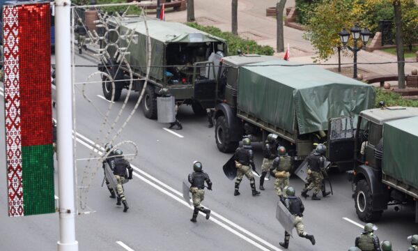 Belarusian law enforcement officers are seen near trucks